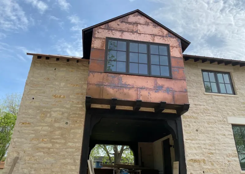 Copper metal panel facade on a stone building for Skylight Installation in Haledon